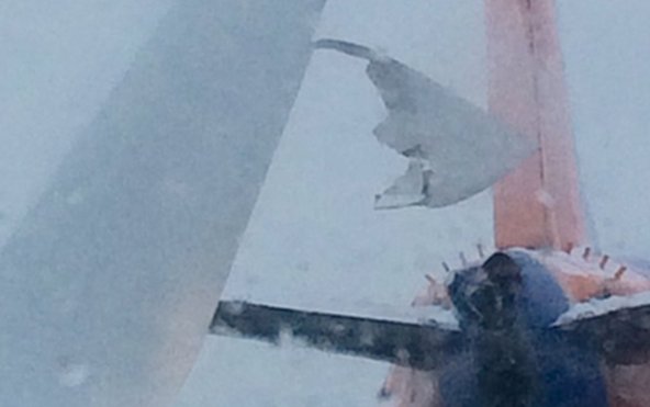 Plane clips another plane's tail at Detroit airport